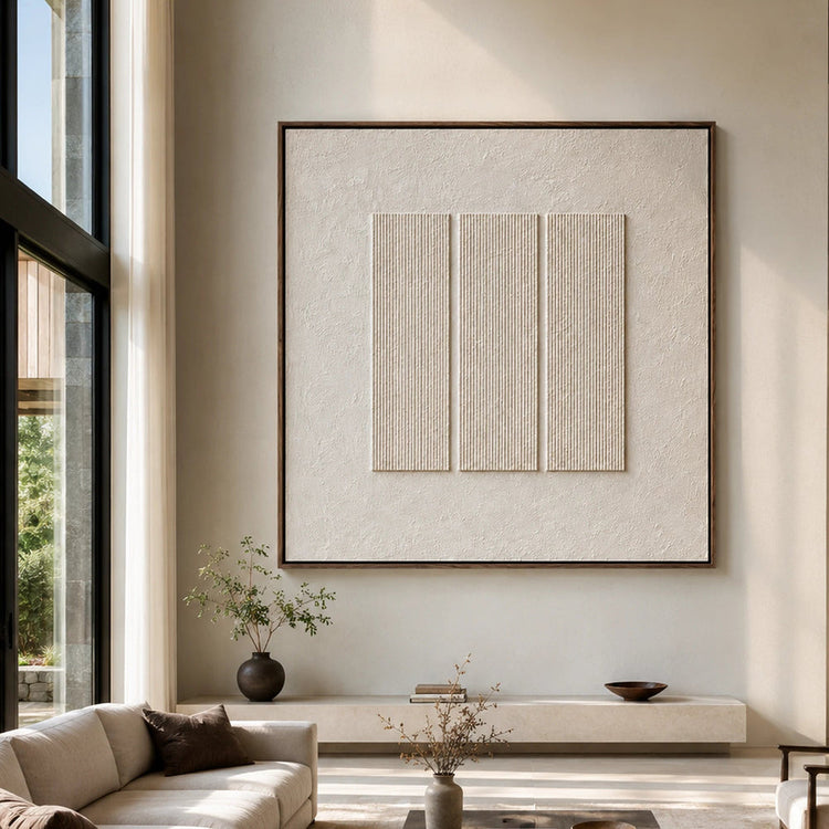 Ivory textured artwork styled above neutral seating